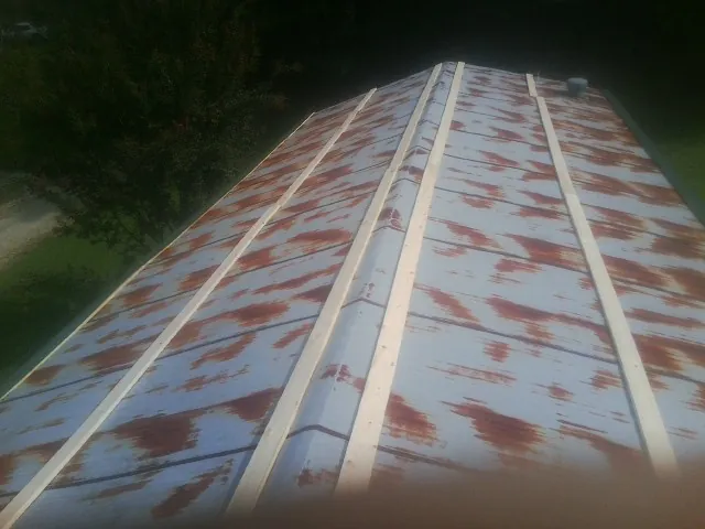 Rusted metal roof panels with new wood purlins before replacement — Storm Damage Roof Repair in Sharon Hill by Roofing Brothers