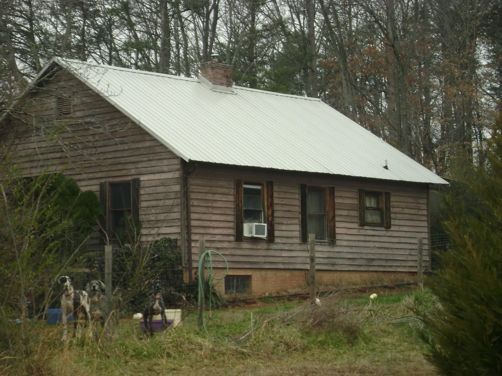 White metal roof on an old wood sided farmhouse, from a Metal Roof Installation job in Sharon Hill