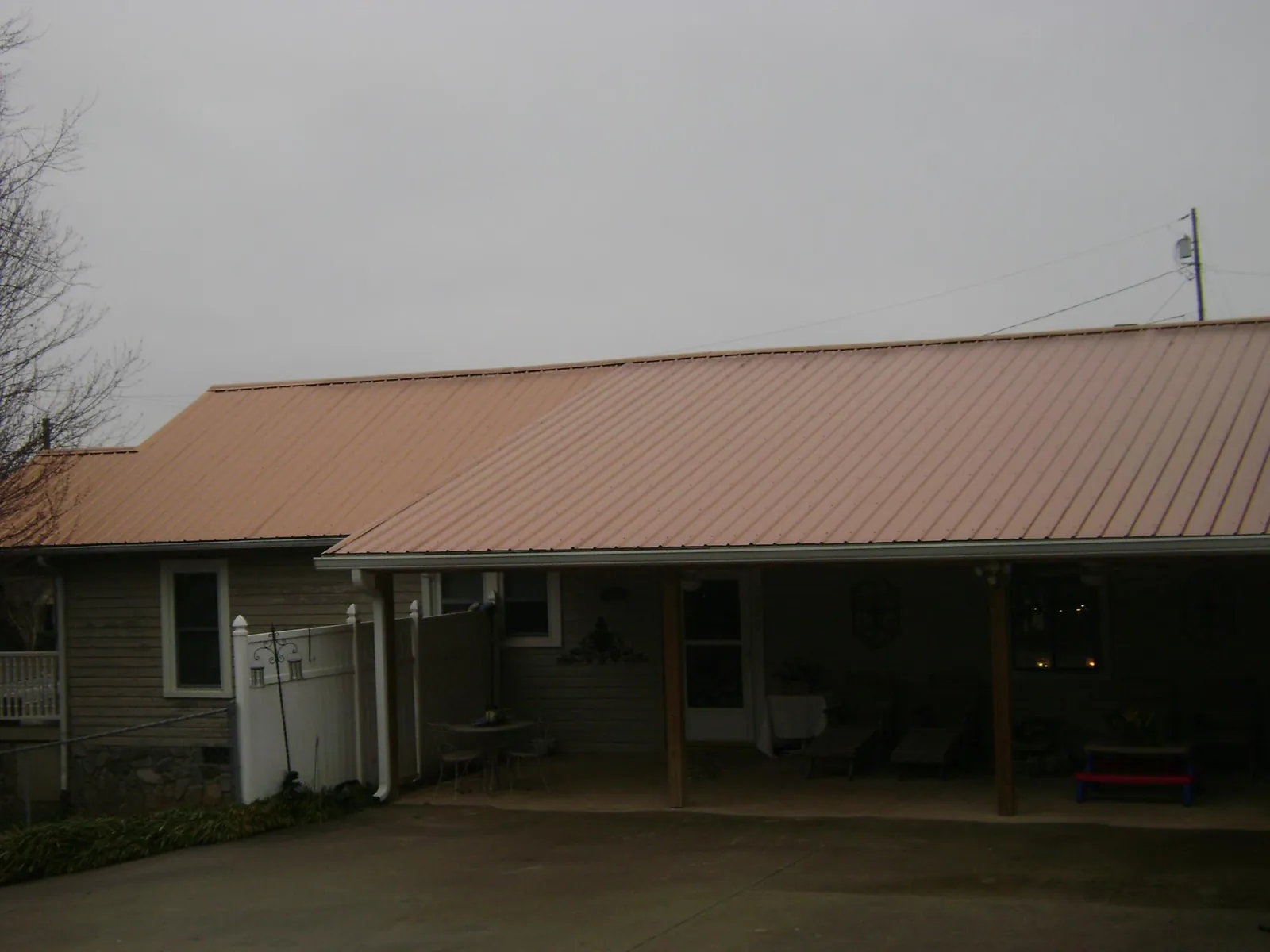 Copper toned metal roof over a wide covered patio in Sharon Hill